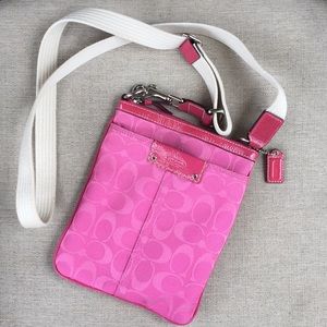 Pink small crossbody COACH bag.